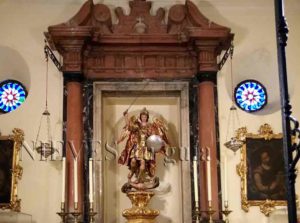 Angel figure among pink marble columns in the Church of the Savior of Seville